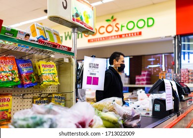 Sterling, USA - April 9, 2020: Social Distancing Sign At Cashier Check-out Aisle Inside Coco's Asian Grocery Shop Store During Coronavirus With Employee In Mask