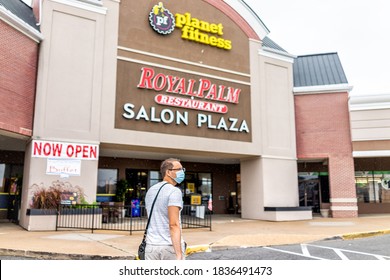 Sterling, USA - September 9, 2020: Storefront At Strip Mall Plaza With People Man Person In Mask Walking Towards Planet Fitness Sign And Now Open During Covid-19