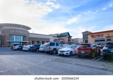 STERLING, VIRGINIA / USA - January 31, 2018: A section of Dulles Town Center showing LA Fitness gym, the Cheesecake factory restaurant and cars parked outside of shopping mall