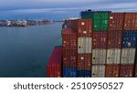 Stern cargo container ship at sunset feight import export container box concept transportation logistics and service to customer and supply change. Vessel ship full load container shipping.