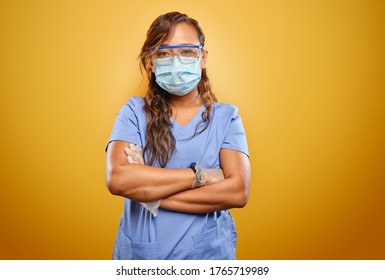 Stern And Strong Filipina Nurse With Arms Crossed Wearing PPE