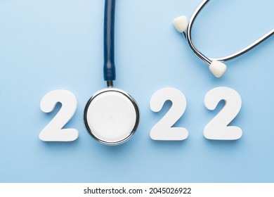 Stethoscope with 2022 number on blue background. Happy New Year for health care and medical banner calendar cover. Creative idea for new trend in medicine treatment and diagnosis concept.