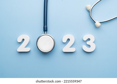Stethoscope with 2023 number on blue background. Happy New Year for health care and medical banner calendar cover. Creative idea for new trend in medicine treatment and diagnosis concept.