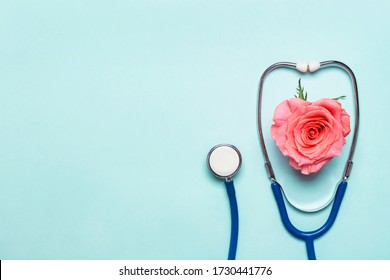 Stethoscope And Beautiful Rose Heart On Blue Background. Thank You Doctor And Nurse Day Concept.