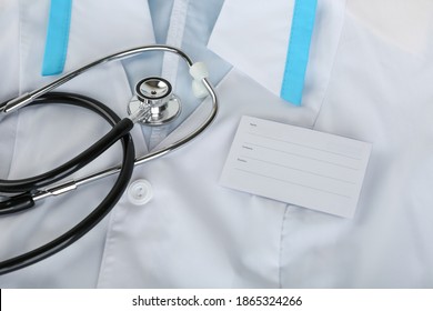 Stethoscope And Blank Name Badge Are On Medical Gown Top View