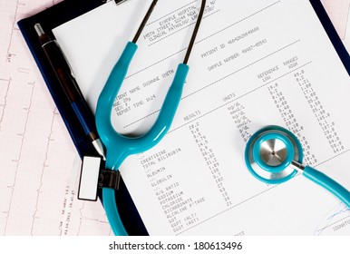 Stethoscope and blood test results on electrocardiogram (ECG) chart 