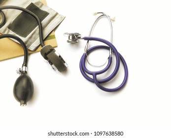 Stethoscope And Book With Blood Pressure Cuff On White Table Floor Background In Medical Instruments Concept, Top View With Space 