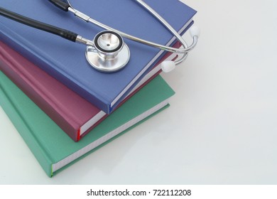 Stethoscope With Books On White Table, Medical Education Concept