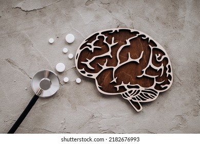 A stethoscope and brain with pills. Awareness of Alzheimer's, Parkinson's disease, dementia, stroke, seizure or mental health. - Shutterstock ID 2182676993
