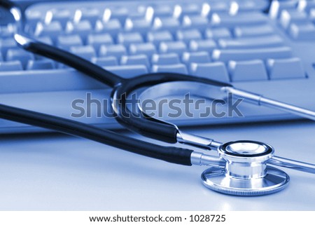 A stethoscope by a computer keyboard.  Computer technology is an integral part of medicine, healthcare, and medical/health insurance today.