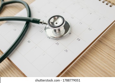 Stethoscope with calendar page date on wood table background doctor appointment medical concept - Shutterstock ID 1788779051