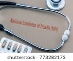 Stethoscope and capsules, digital composition with the text National Institutes of Health (NIH), conceptual image