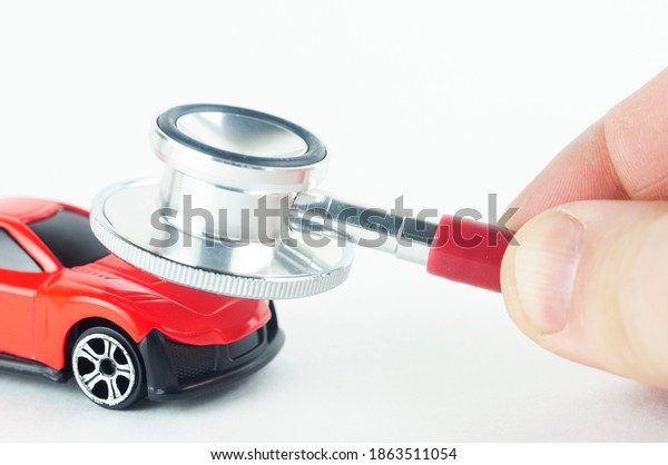 a stethoscope and a car concept of repair and\
diagnostics of the car