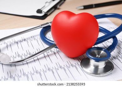Stethoscope, cardiogram and red decorative heart on wooden background, closeup. Cardiology concept