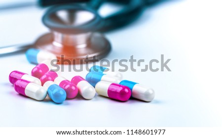 Stethoscope and colorful capsule pills on doctor table or nurse desk. Health checkup. Medical healthcare and medicine background. Physician tool for patient diagnosis. Cardiology doctor equipment.