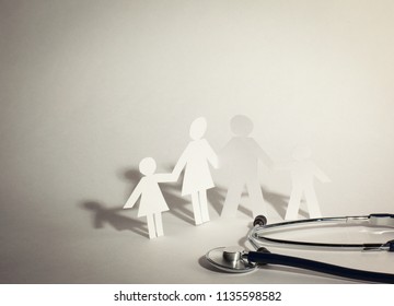 Stethoscope And The Family Paper Doll.the Concept Of Health.