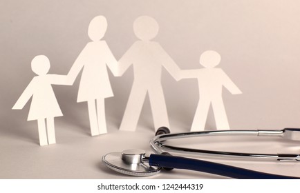 Stethoscope And The Family Paper Doll.the Concept Of Health.