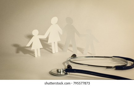 Stethoscope And The Family Paper Doll.the Concept Of Health.