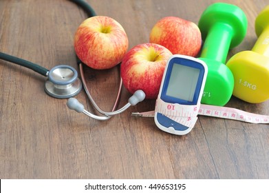 Stethoscope With Glucose Meter,fruits And Dumbbells For Using In Fitness, Concept To Control Diabetes, Exercise In Diabetes Patients Concept.