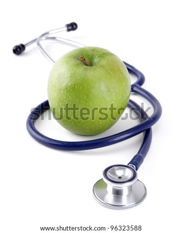 Stethoscope and green apple isolated on white background