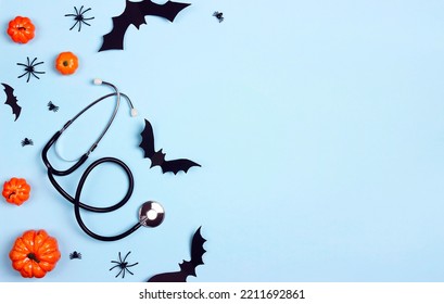 Stethoscope and Halloween decorations on blue background with copy space. Party invitation, Medical Halloween greeting card. - Shutterstock ID 2211692861
