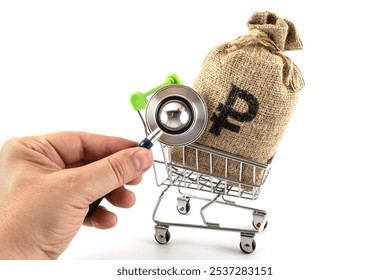 Stethoscope in hand and money bag with Russian ruble symbol - Powered by Shutterstock