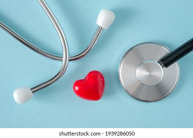 Stethoscope And Heart On Blue Background, Top View, Flat Lay. Heart Health, Health Care Concept. 