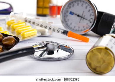 stethoscope, insulin syringe and different medicament on medical form - Powered by Shutterstock