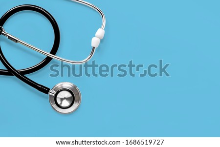 Stethoscope isolated on blue background. The stethoscope is a medical instrument for listening to the action of someone's heart or breathing. with copy space for your text.