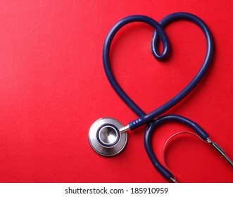 Stethoscope isolated on red background