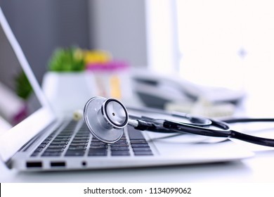 Stethoscope lying on a laptop keyboard in a concept of online medicine or troubleshooting the computer viewed low angle with copy space - Powered by Shutterstock