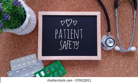 Stethoscope, Medicine, Chalk Board And Flower With Inscription Patient Safety On A Wooden Table. Medical And Health Care Concept.