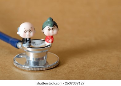 Stethoscope with Miniature Older Couple Representing Geriatric Health and Medical Support