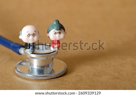 Stethoscope with Miniature Older Couple Representing Geriatric Health and Medical Support