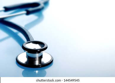 Stethoscope on blue background - Shutterstock ID 144549545