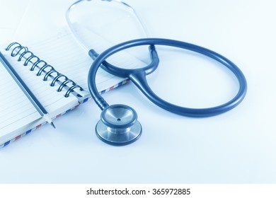 stethoscope on blue background - Shutterstock ID 365972885