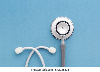 Stethoscope on blue background - Shutterstock ID 572936818