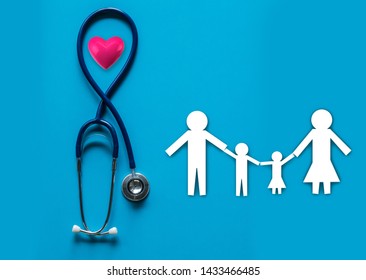 stethoscope on blue background with family paper health medical insurance copy space