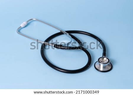 Stethoscope on Blue Background. Stethoscope isolated on blue background. The stethoscope is a medical instrument for listening to the action of someone's heart or breathing.