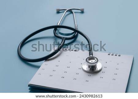 Stethoscope on calendar with soft focus and northern lights, annual checkup concept in the background.
