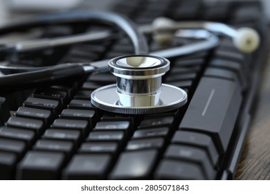 Stethoscope on a computer keyboard - concept online medical healthcare 
