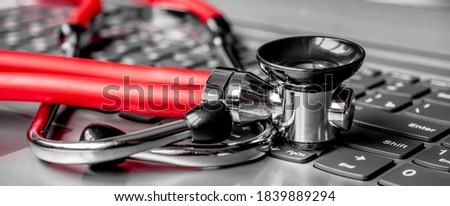 Stethoscope on a computer keyboard. Computer technology is an integral part of medicine, healthcare, and medical health insurance today. Focus on keyboard. Artistic defocus