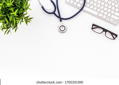 Stethoscope On Doctor Office Desk. White Background Top View Space For Text