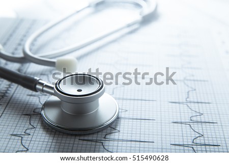 Stethoscope on EKG graph background. Medicine concept