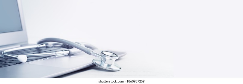 Stethoscope On A Laptop. Virus Season, Pandemic. Remote Medicine Or Elearning And Telemedicine And Consultation Advice. Copy Space. Medical Network Or Contact Us Banner