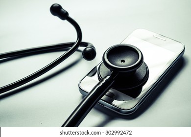 stethoscope on smartphone - checking security on smartphone concept