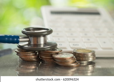 Stethoscope On Stack Of Coins With Calculator, Concept Of Financial Health