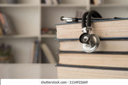 stethoscope on stack of medical guide book for doctor learning treatment at hospital. - Powered by Shutterstock