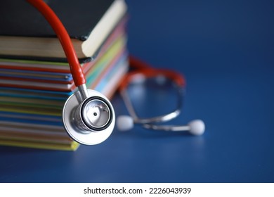 stethoscope on stack of medical guide book for doctor learning treatment hospital. - Shutterstock ID 2226043939