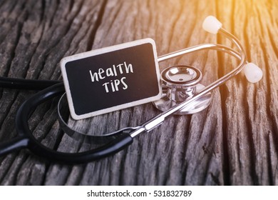 Stethoscope On Wood With Health Tips Word As Medical Concept